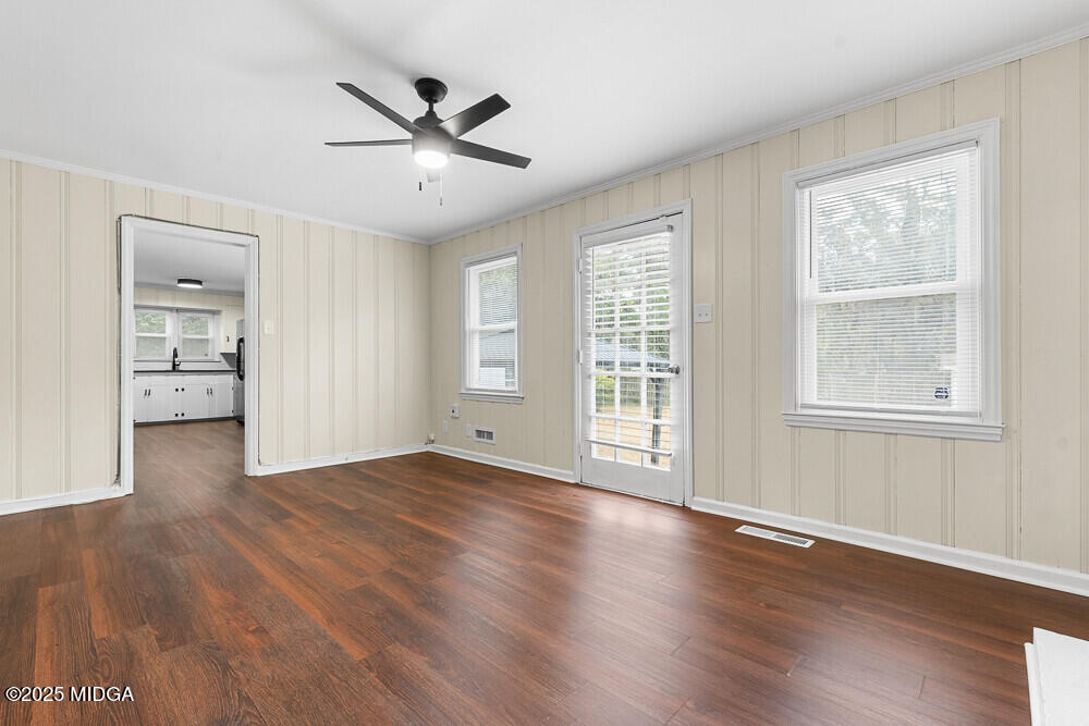 127 Edna Place Warner Robins, GA 31093 - Photo 14 of 26 a view of an empty room with a window and wooden floor