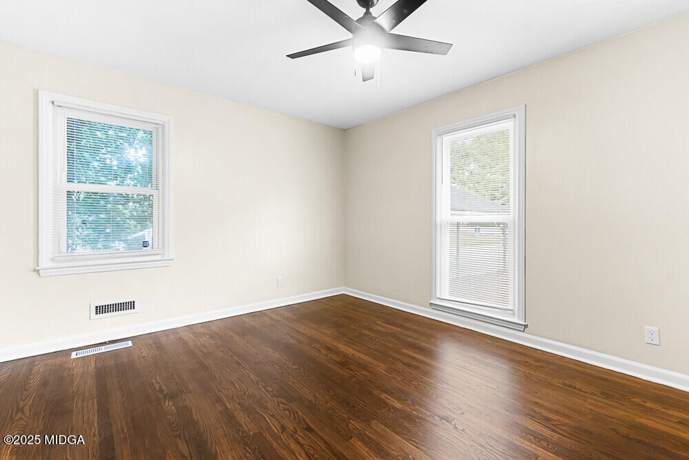 127 Edna Place Warner Robins, GA 31093 - Photo 16 of 26 wooden floor in an empty room with a window