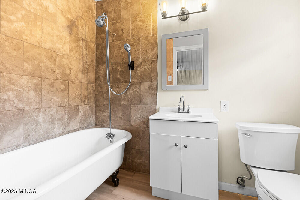 127 Edna Place Warner Robins, GA 31093 - Photo 17 of 26 a bathroom with a sink a toilet and shower