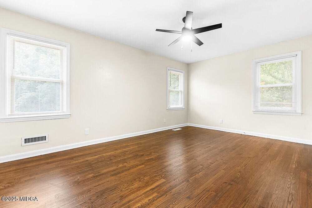 127 Edna Place Warner Robins, GA 31093 - Photo 18 of 26 a view of an empty room with wooden floor and a window