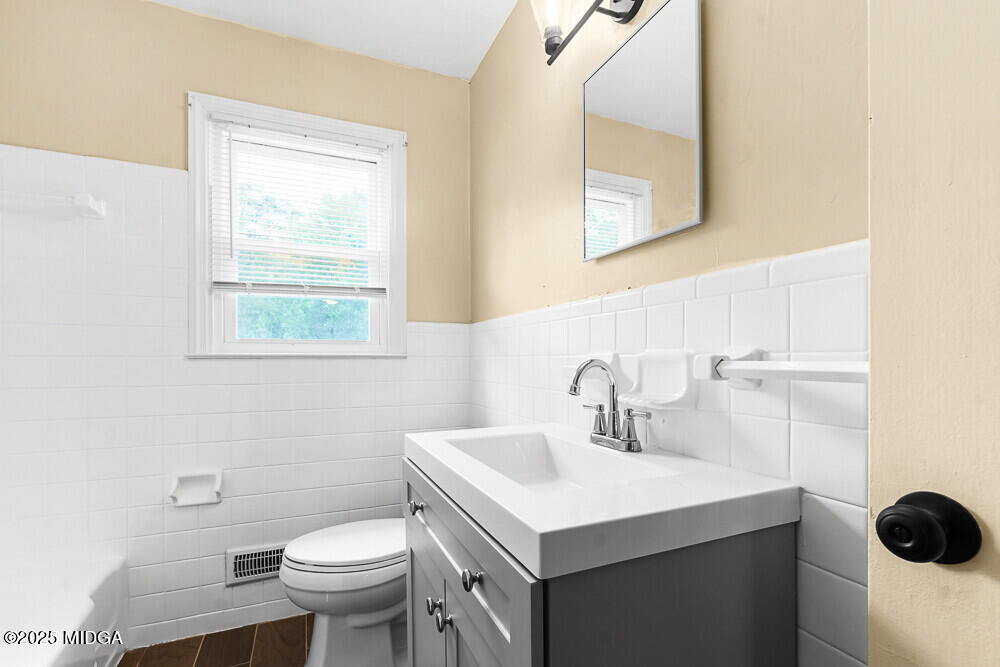 127 Edna Place Warner Robins, GA 31093 - Photo 20 of 26 a bathroom with a sink toilet and mirror