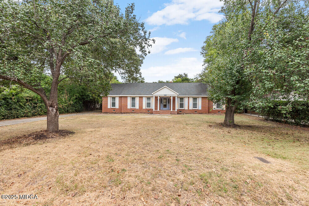 127 Edna Place Warner Robins, GA 31093 - Photo 2 of 26 a front view of a house with a garden