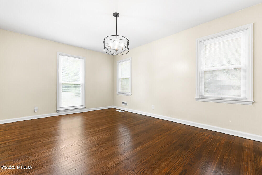 127 Edna Place Warner Robins, GA 31093 - Photo 7 of 26 an empty room with wooden floor and windows