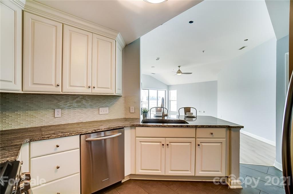 1342 Torrence Circle Davidson, NC 28036 - Photo 11 of 39 a kitchen with granite countertop a sink and cabinets