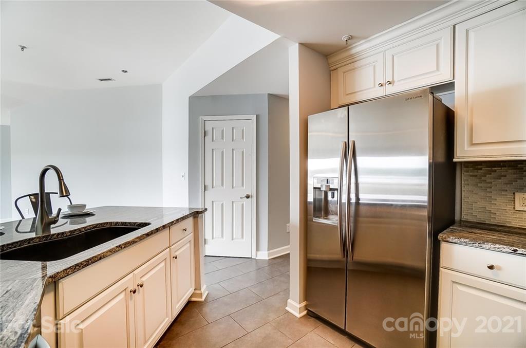 1342 Torrence Circle Davidson, NC 28036 - Photo 12 of 39 a kitchen with stainless steel appliances granite countertop a refrigerator and a stove