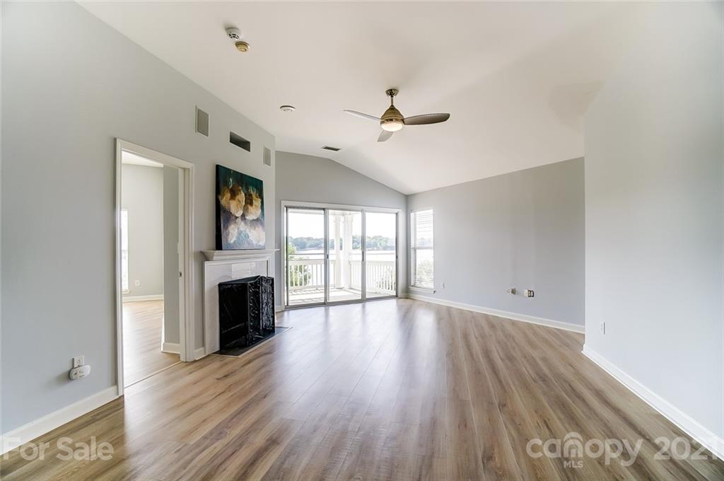 1342 Torrence Circle Davidson, NC 28036 - Photo 13 of 39 a view of an empty room with a fireplace and a window