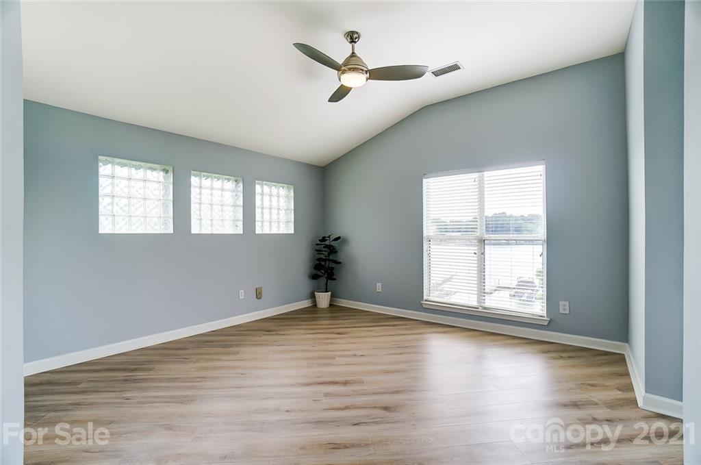 1342 Torrence Circle Davidson, NC 28036 - Photo 17 of 39 a view of empty room with wooden floor and fan