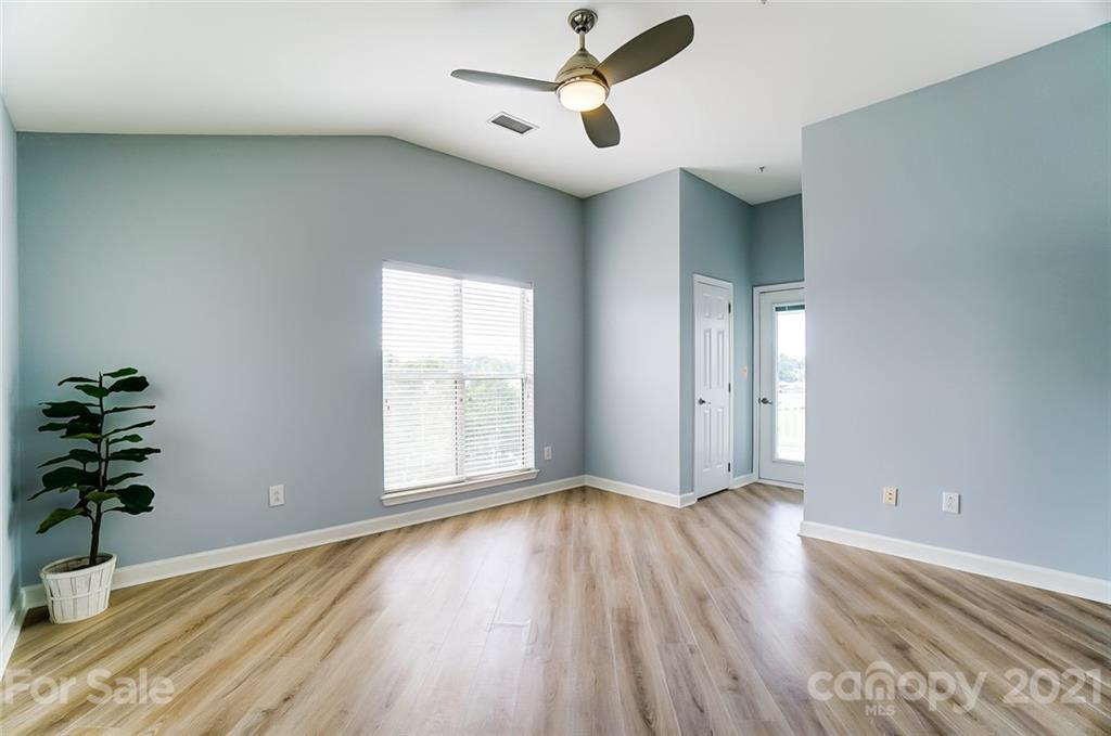 1342 Torrence Circle Davidson, NC 28036 - Photo 18 of 39 an empty room with wooden floor and windows