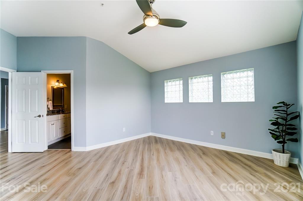 1342 Torrence Circle Davidson, NC 28036 - Photo 19 of 39 a view of an empty room with a window and wooden floor