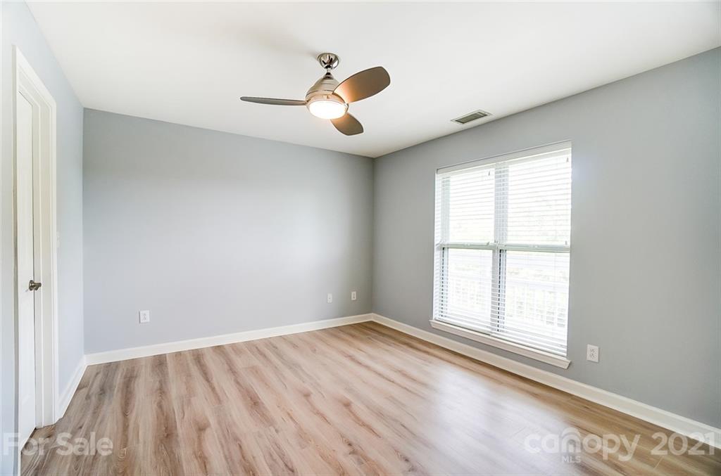 1342 Torrence Circle Davidson, NC 28036 - Photo 25 of 39 an empty room with windows and chandelier fan