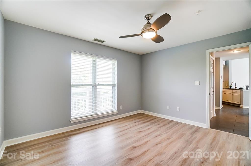 1342 Torrence Circle Davidson, NC 28036 - Photo 26 of 39 an empty room with wooden floor and windows
