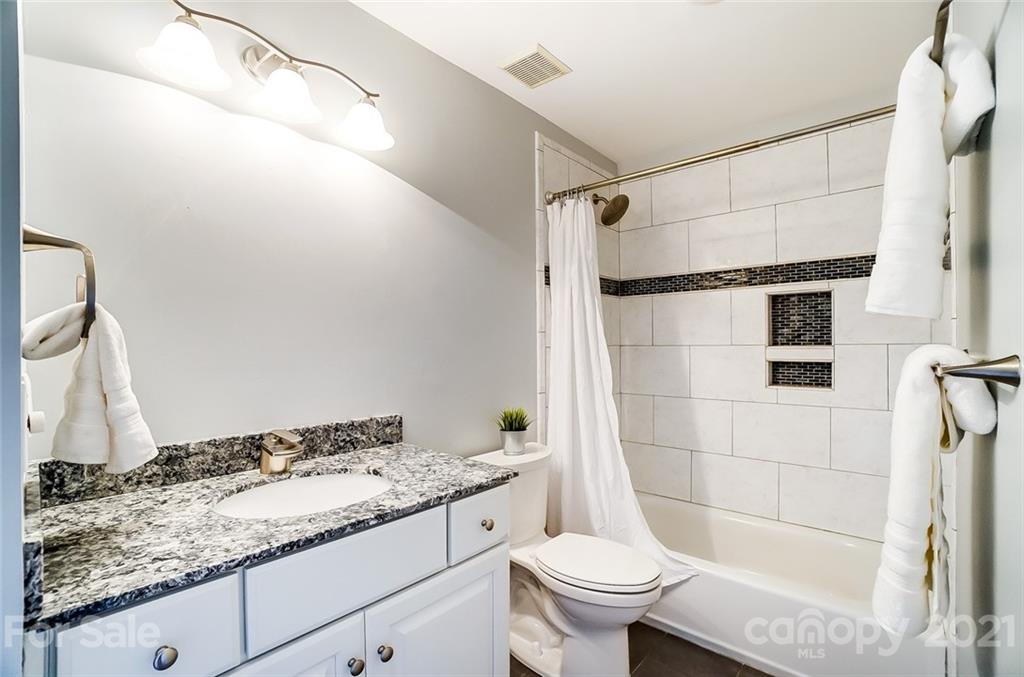 1342 Torrence Circle Davidson, NC 28036 - Photo 28 of 39 a bathroom with a granite countertop sink toilet and shower