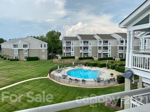 1342 Torrence Circle Davidson, NC 28036 - Photo 4 of 39 a view of a house with a swimming pool and a yard
