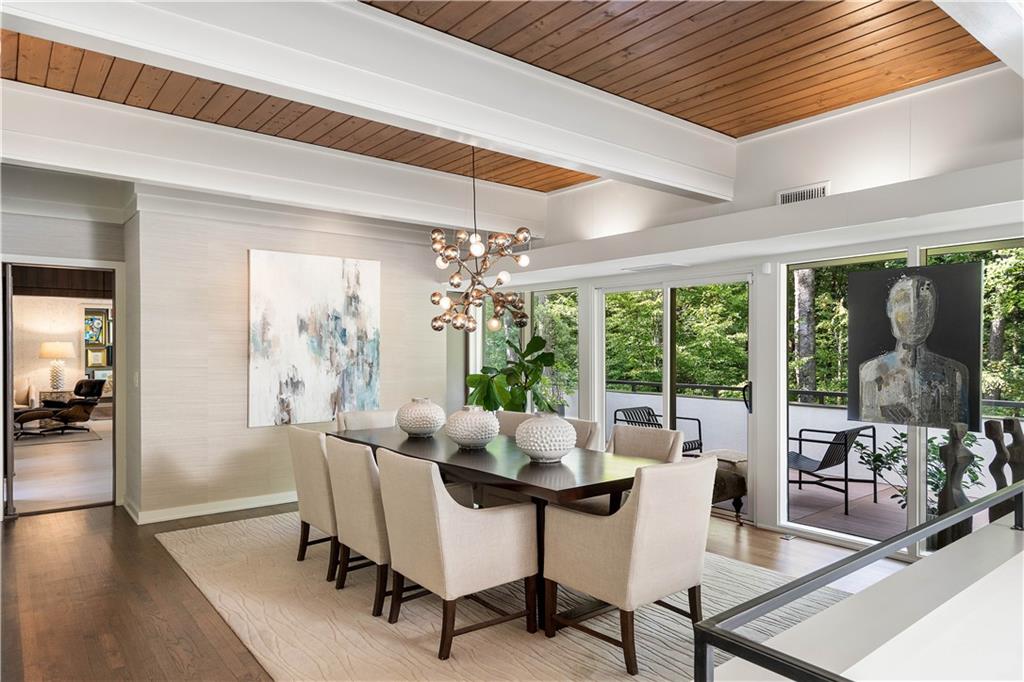 1640 Winterthur Close Northwest Atlanta, GA 30328 - Photo 13 of 57 a dining room with furniture a chandelier and wooden floor