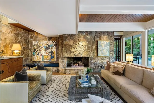 a bedroom with furniture and a large window