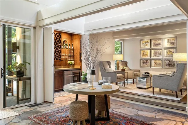 a bedroom with furniture large window and fireplace