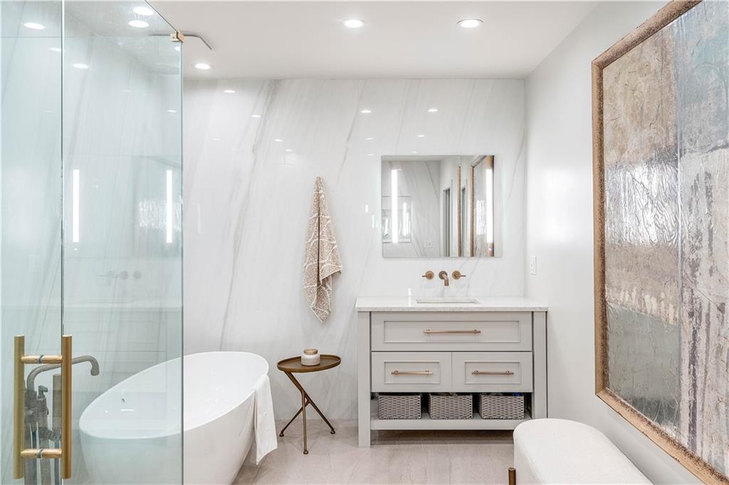 1640 Winterthur Close Northwest Atlanta, GA 30328 - Photo 26 of 57 a bathroom with a sink tub vanity and a toilet