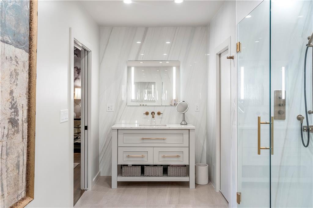 1640 Winterthur Close Northwest Atlanta, GA 30328 - Photo 28 of 57 a bathroom with a sink vanity and a mirror