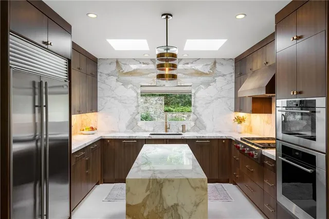 a stove top oven sitting inside of a kitchen