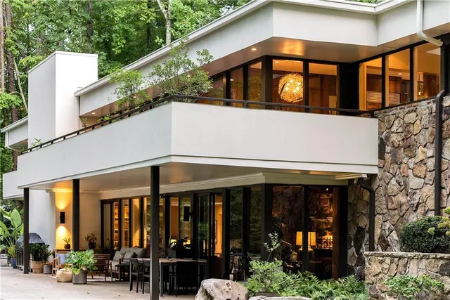 a view of a backyard with a small pool and sitting area