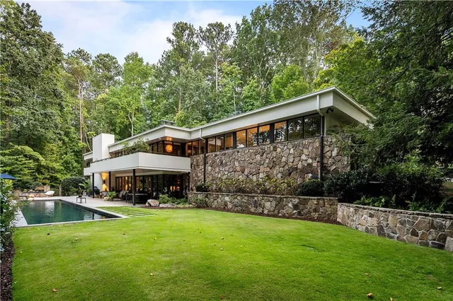 a view of house with yard outdoor seating and green space