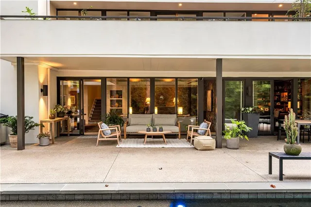 a swimming pool with outdoor seating and yard