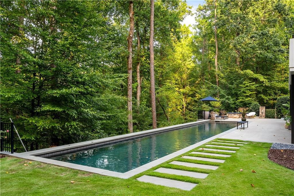 1640 Winterthur Close Northwest Atlanta, GA 30328 - Photo 52 of 57 a view of a backyard with a small pool and sitting area