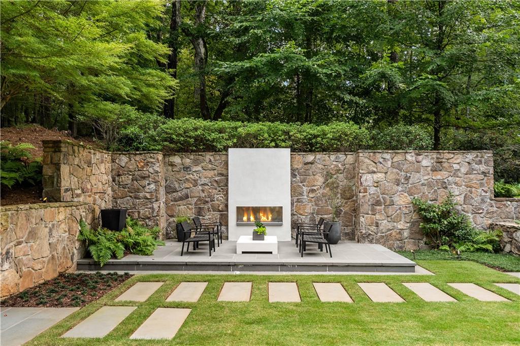 1640 Winterthur Close Northwest Atlanta, GA 30328 - Photo 53 of 57 a view of house with yard outdoor seating and green space