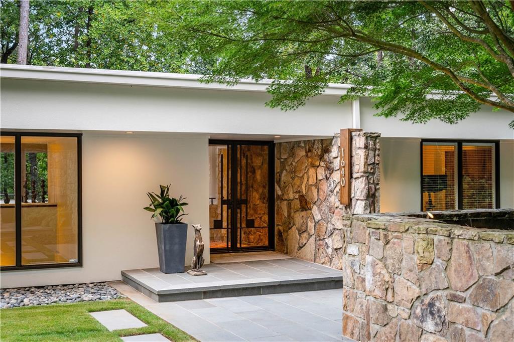 1640 Winterthur Close Northwest Atlanta, GA 30328 - Photo 56 of 57 a front view of a house with garden