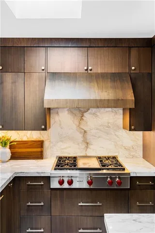 a living room with a couch and a stove top oven