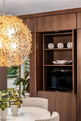 a dining room with furniture a chandelier and wooden floor