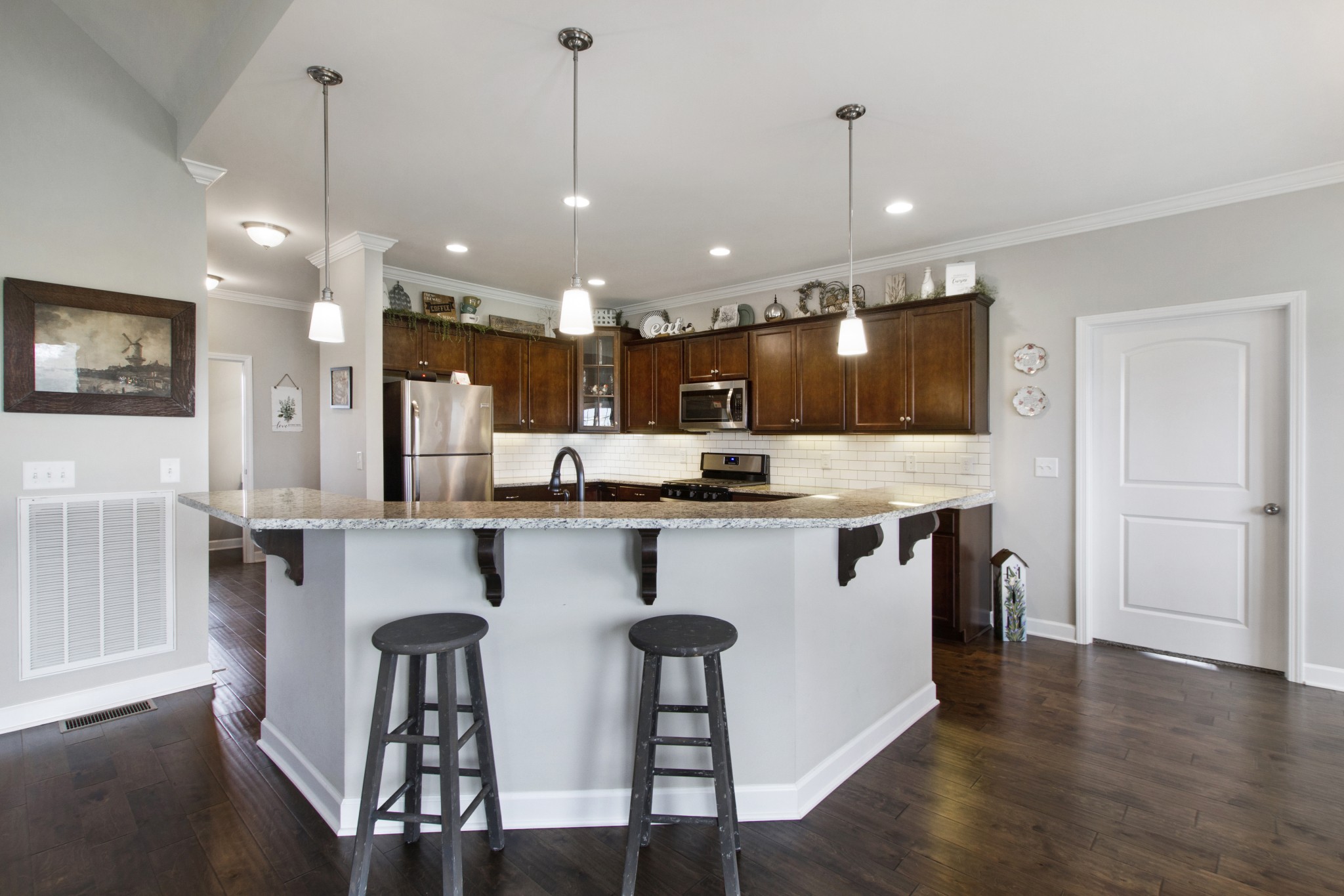 1091 Caballo Trail Gallatin, TN 37066 - Photo 8 of 30 a kitchen with stainless steel appliances kitchen island a refrigerator and a wooden cabinets