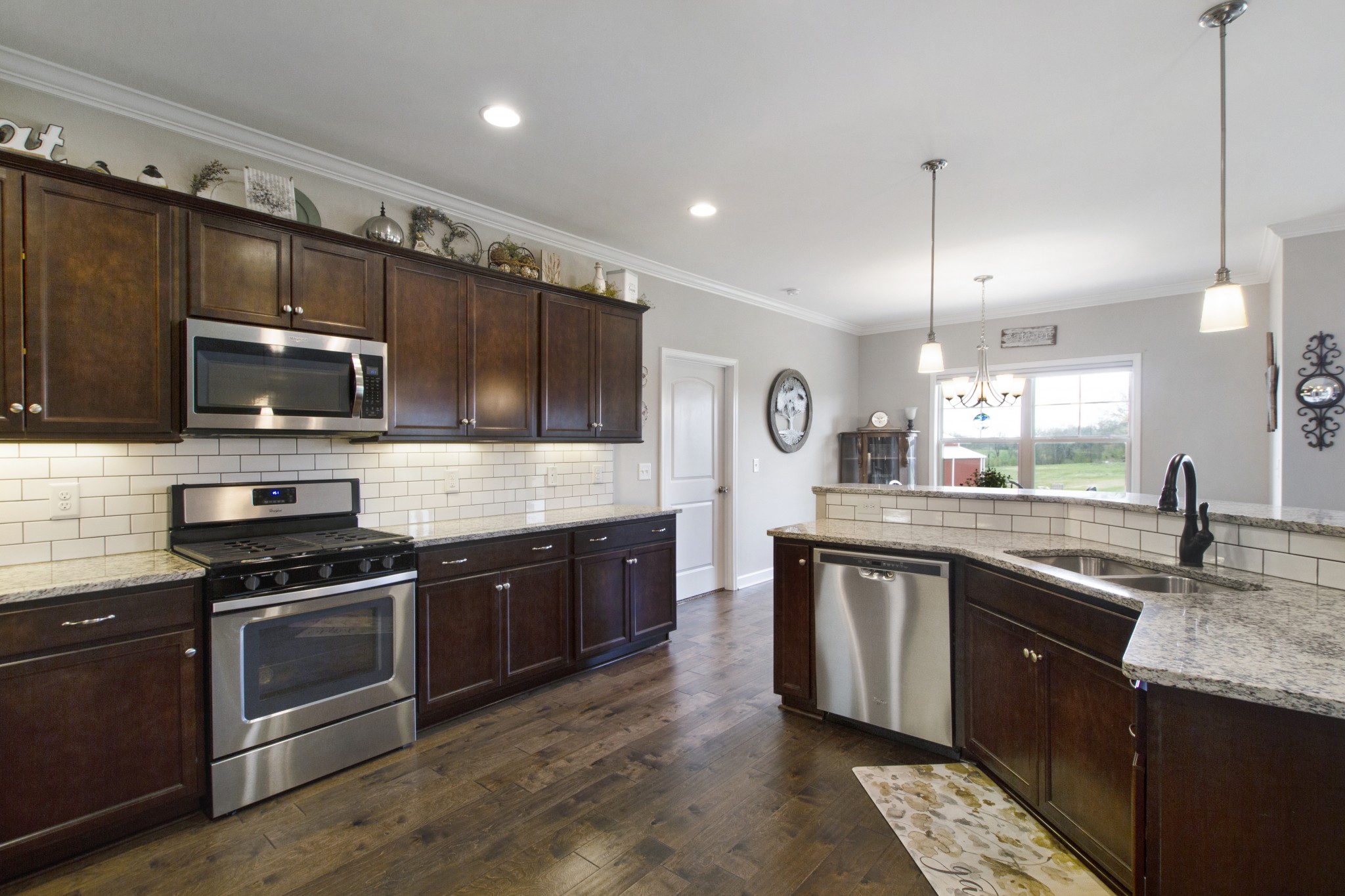 1091 Caballo Trail Gallatin, TN 37066 - Photo 9 of 30 a large kitchen with granite countertop stainless steel appliances and wooden cabinets