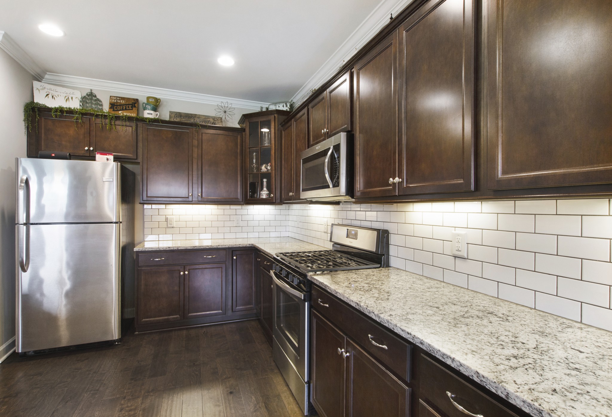 1091 Caballo Trail Gallatin, TN 37066 - Photo 10 of 30 a kitchen with granite countertop stainless steel appliances and wooden cabinets