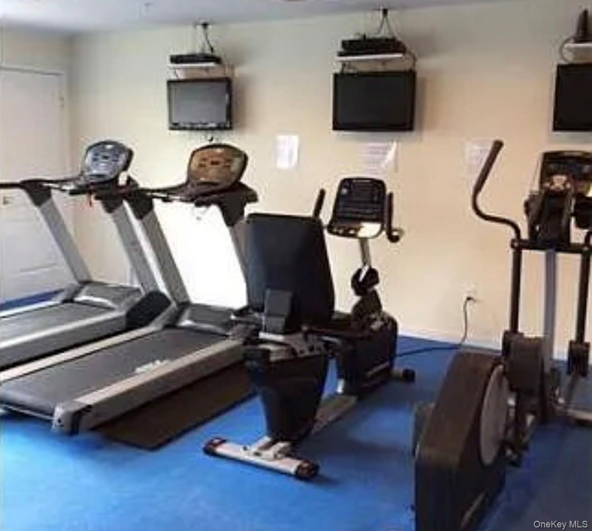 3 Cross Street, Unit 304 Suffern, NY 10901 - Photo 14 of 18 a room with gym equipment and wooden floor