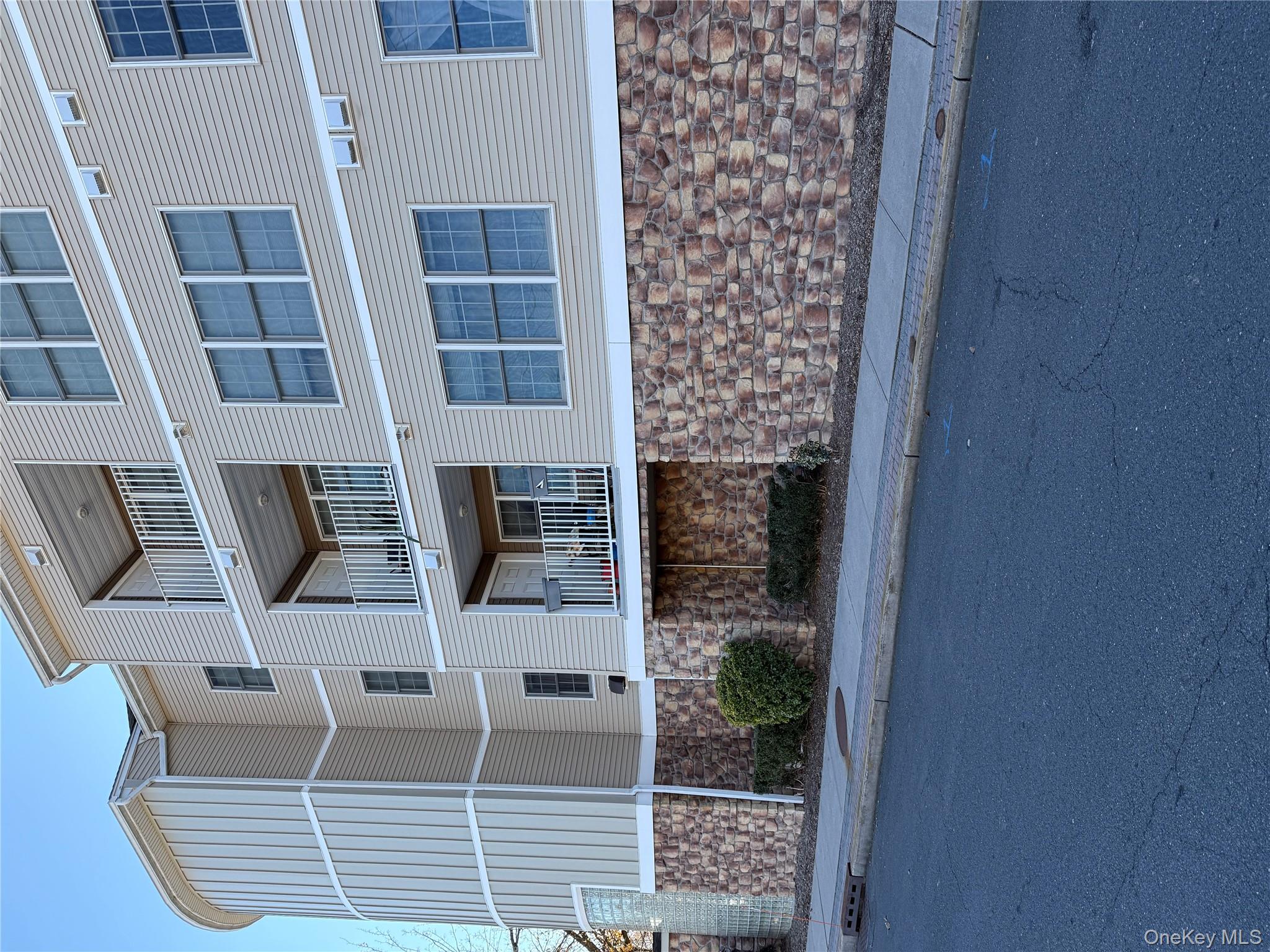 3 Cross Street, Unit 304 Suffern, NY 10901 - Photo 2 of 18 a front view of a building with garage