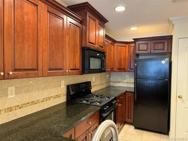a kitchen with granite countertop stainless steel appliances and wooden cabinets
