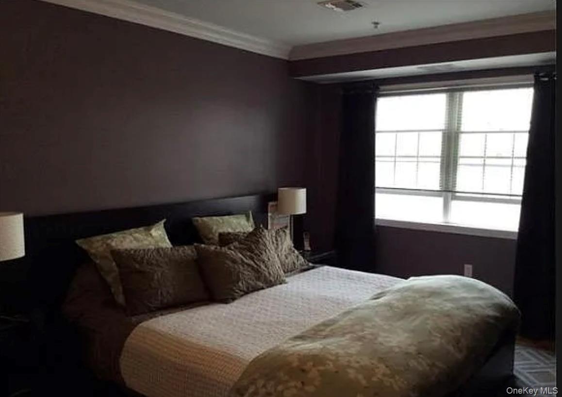3 Cross Street, Unit 304 Suffern, NY 10901 - Photo 8 of 18 a bedroom with a bed and a window
