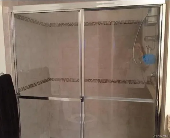 a bathroom with a glass shower door
