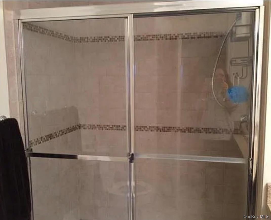 3 Cross Street, Unit 304 Suffern, NY 10901 - Photo 10 of 18 a bathroom with a glass shower door