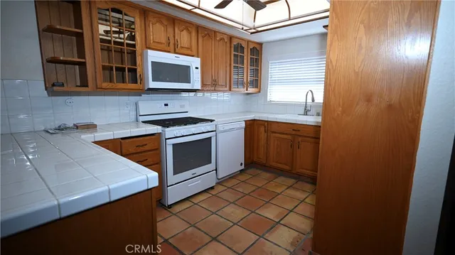 a kitchen with stainless steel appliances a stove and a microwave