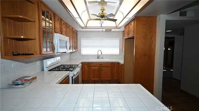 a kitchen with stainless steel appliances a stove and cabinets