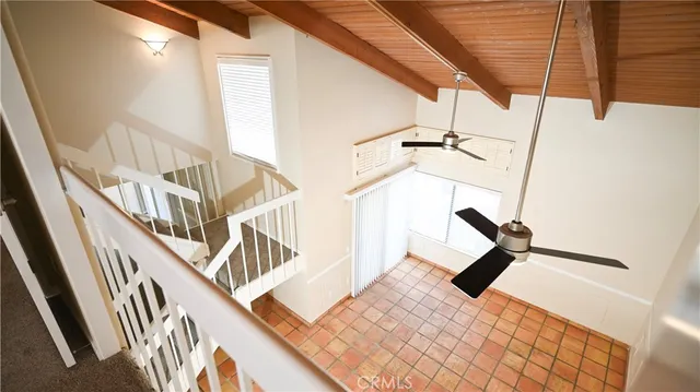 a view of a livingroom with wooden floor and stairs