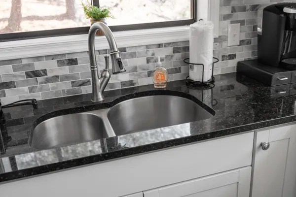 a bathroom with a sink vanity mirror and toilet