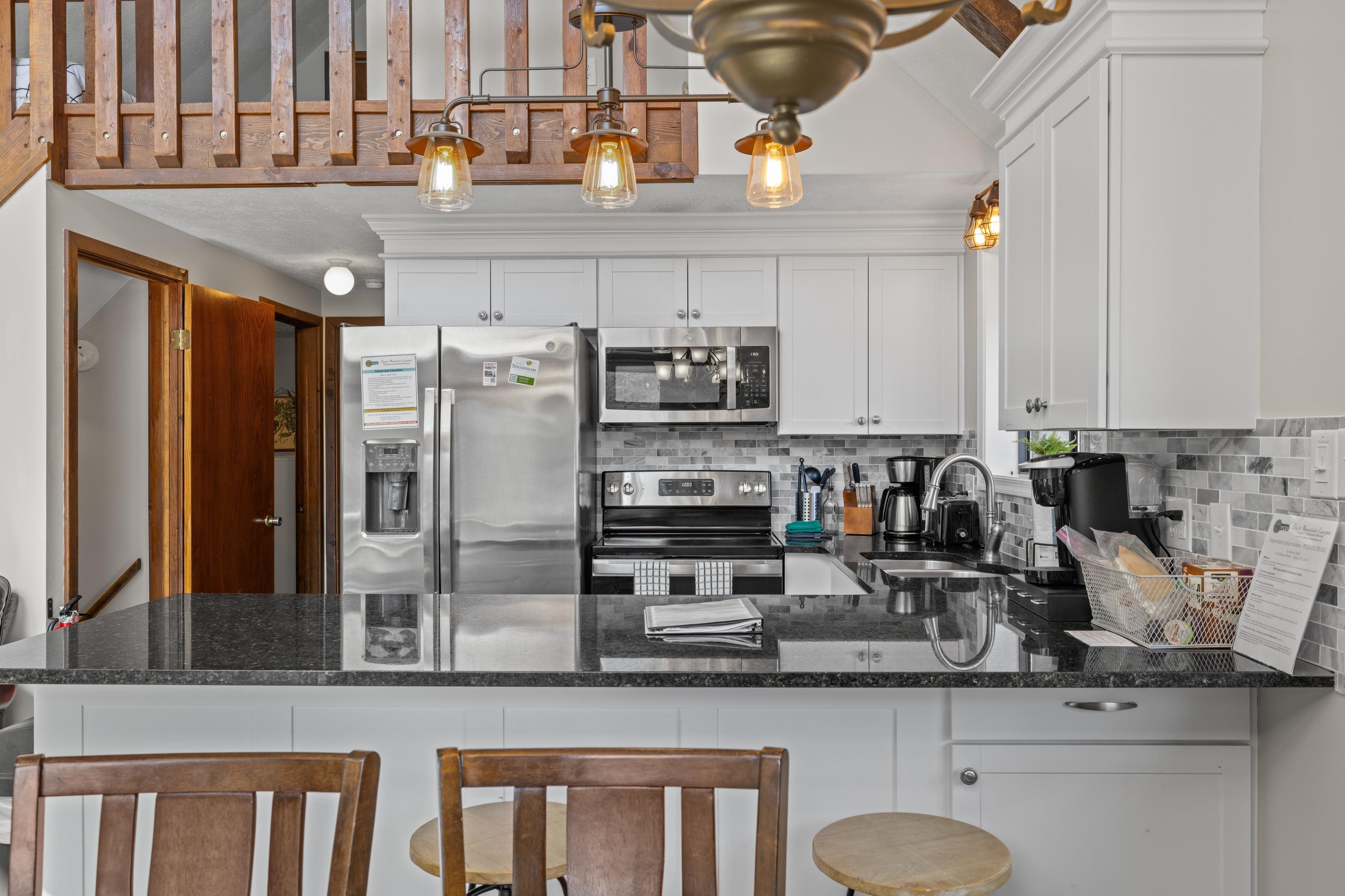 673 Killmon Road Basye, VA 22810 - Photo 16 of 74 a kitchen with stainless steel appliances granite countertop a sink and cabinets