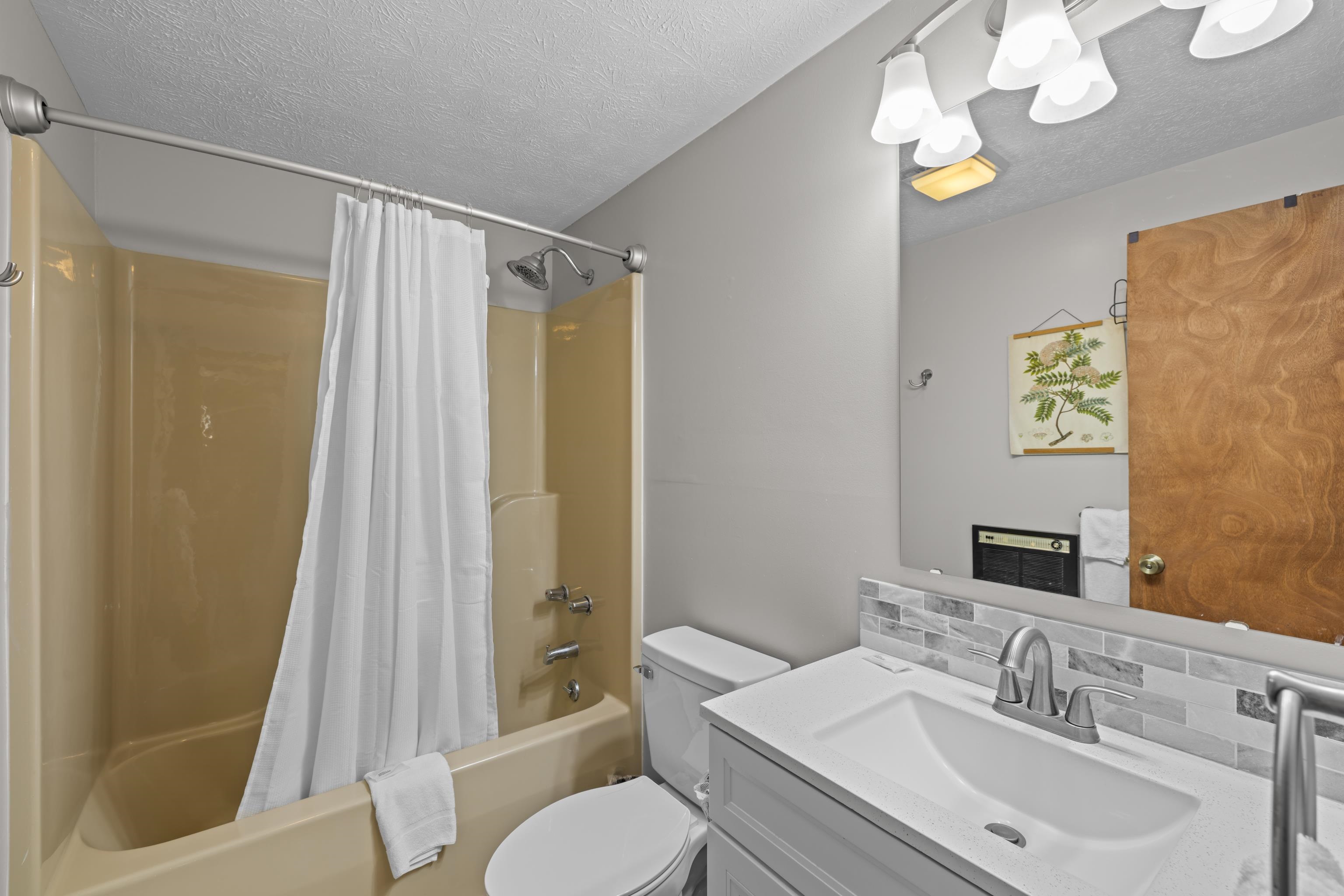 673 Killmon Road Basye, VA 22810 - Photo 21 of 74 a bathroom with a sink vanity mirror and toilet