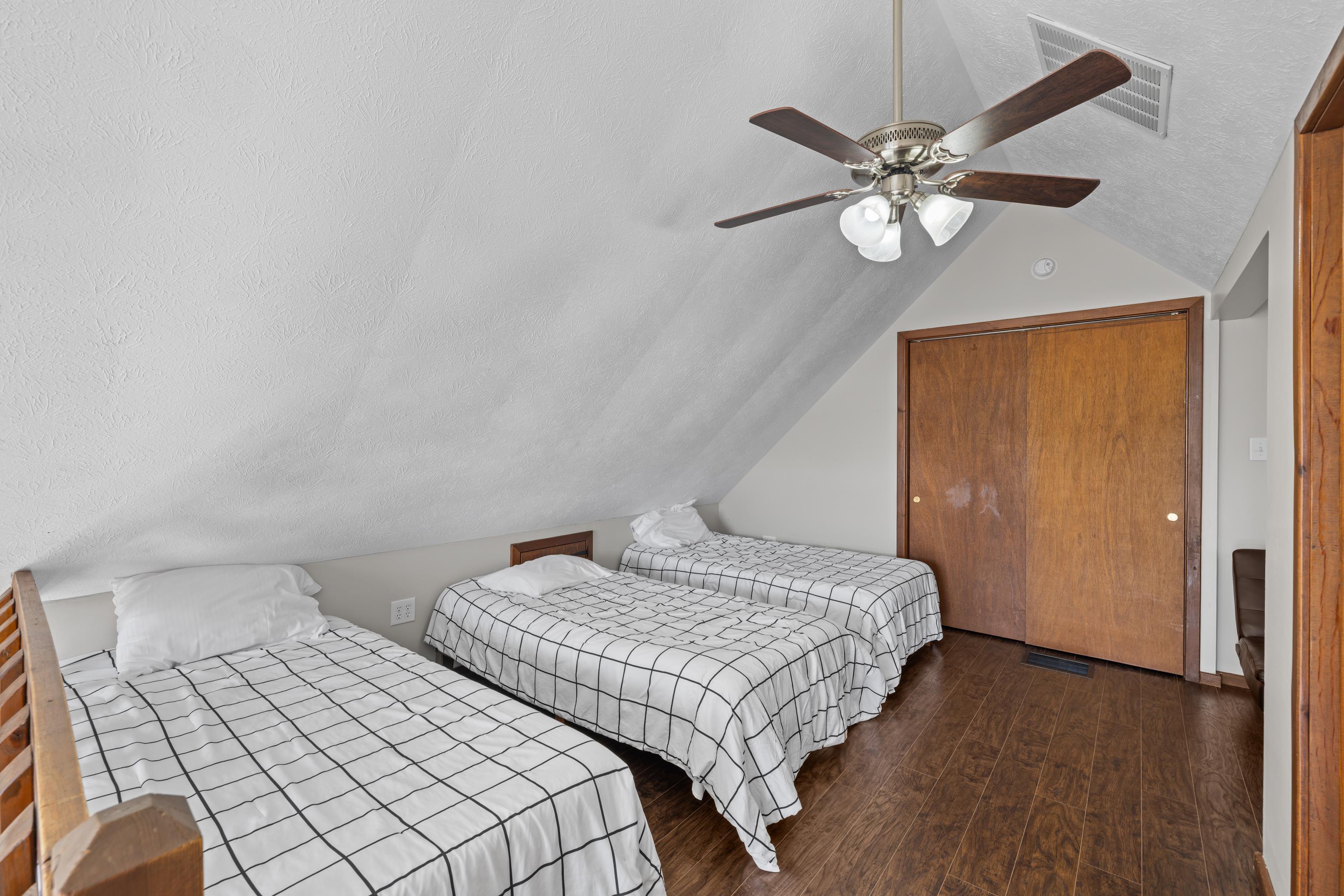 673 Killmon Road Basye, VA 22810 - Photo 28 of 74 a bedroom with two beds and a chandelier