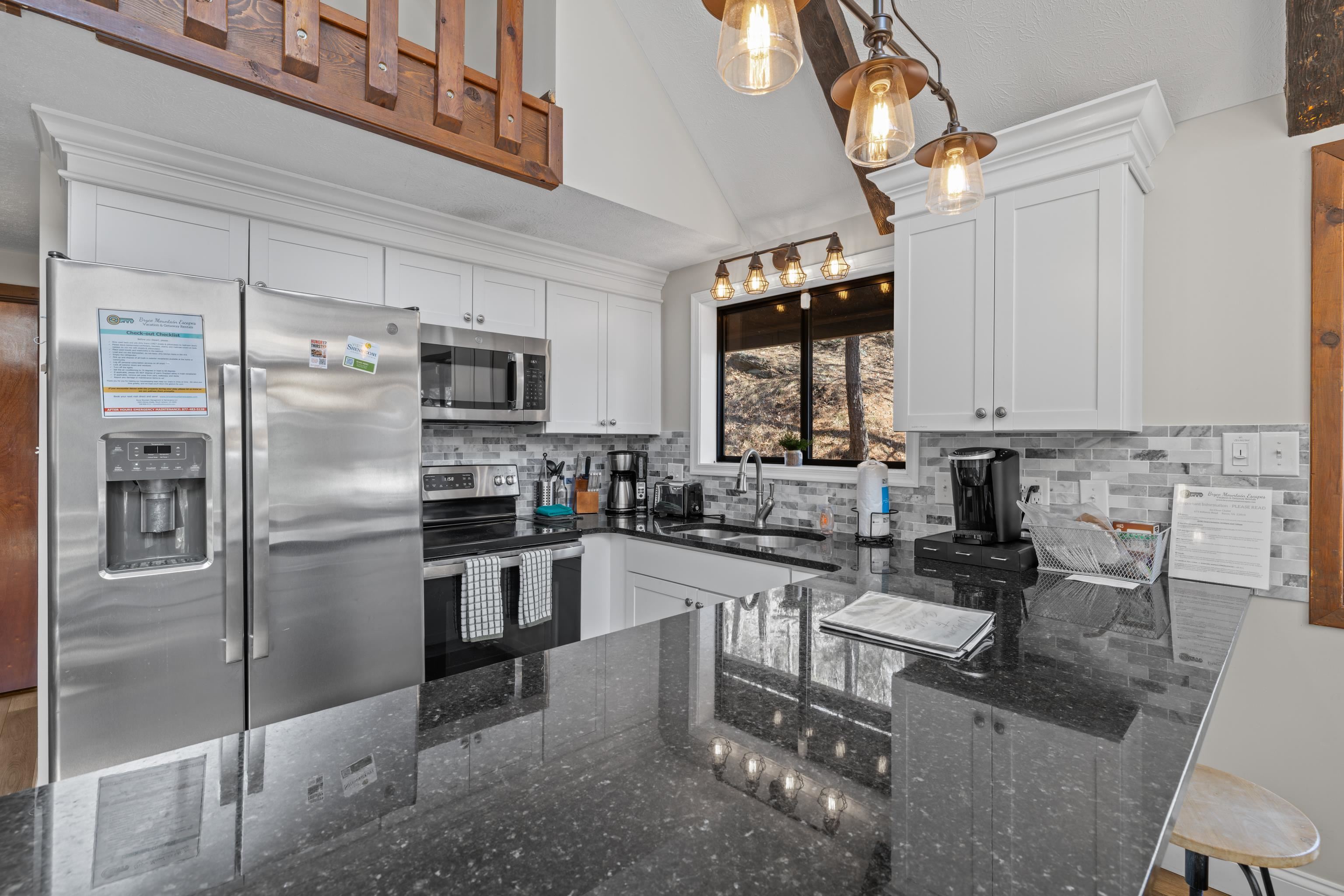 673 Killmon Road Basye, VA 22810 - Photo 9 of 74 a kitchen with stainless steel appliances granite countertop a sink a stove a refrigerator cabinets and a dining table