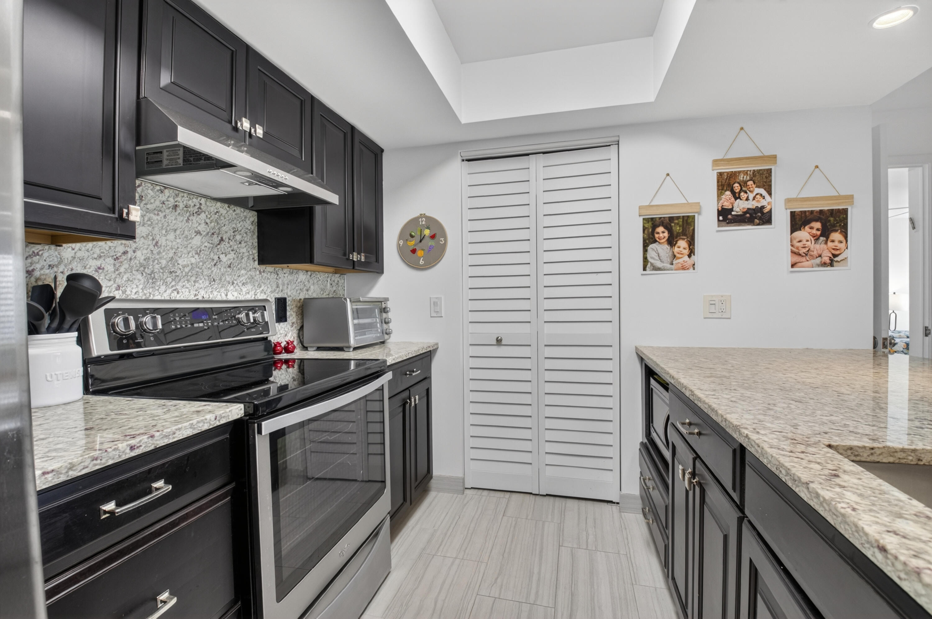 19981 Boca W Drive, Unit 3123 Boca Raton, FL 33434 - Photo 2 of 57 a kitchen with stainless steel appliances granite countertop a stove and a sink