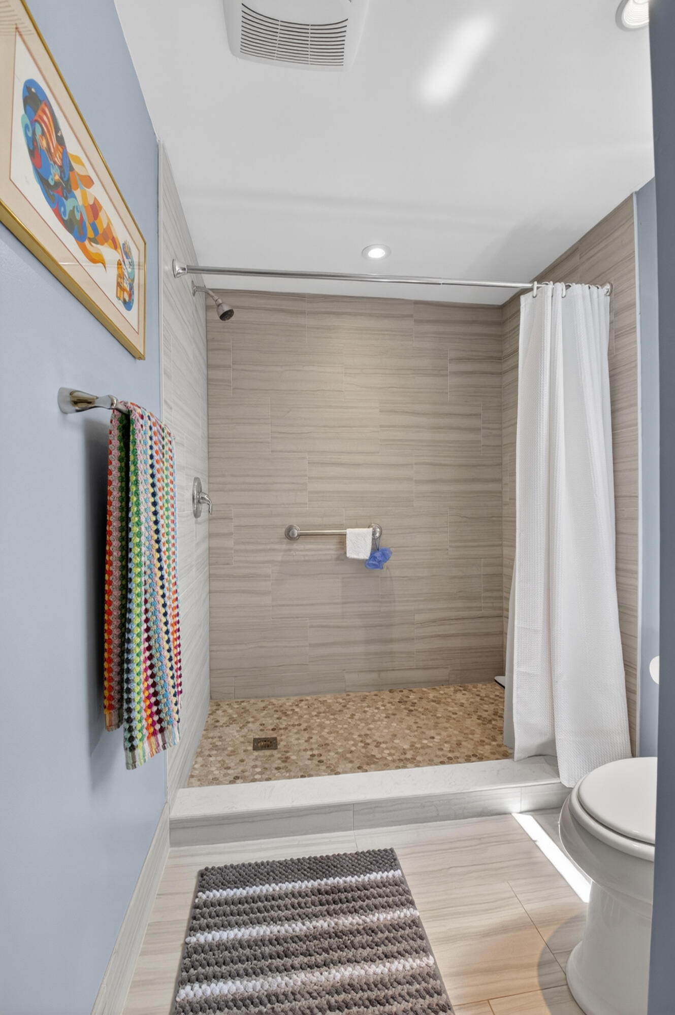 19981 Boca W Drive, Unit 3123 Boca Raton, FL 33434 - Photo 23 of 57 a view of a bathroom with a sink and a rug
